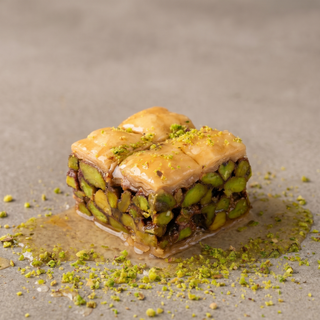 Pistachio square baklava on a stone surface, premium gift sweet